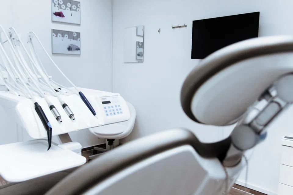 Empty modern dental treatment room with a dental chair (stock photograph)
